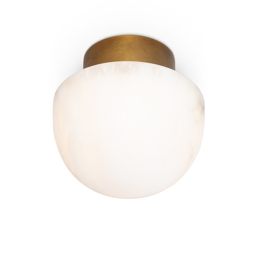 Alabaster flush mount light with natural brass base turned on